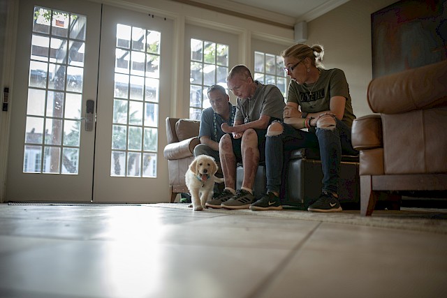 The Sutterfield family sits in the living area of a Fisher House. Zachary Sutterfield was severly injured in a fire. His parents, both veterans, have supported him during his recovery and rehabilitation.